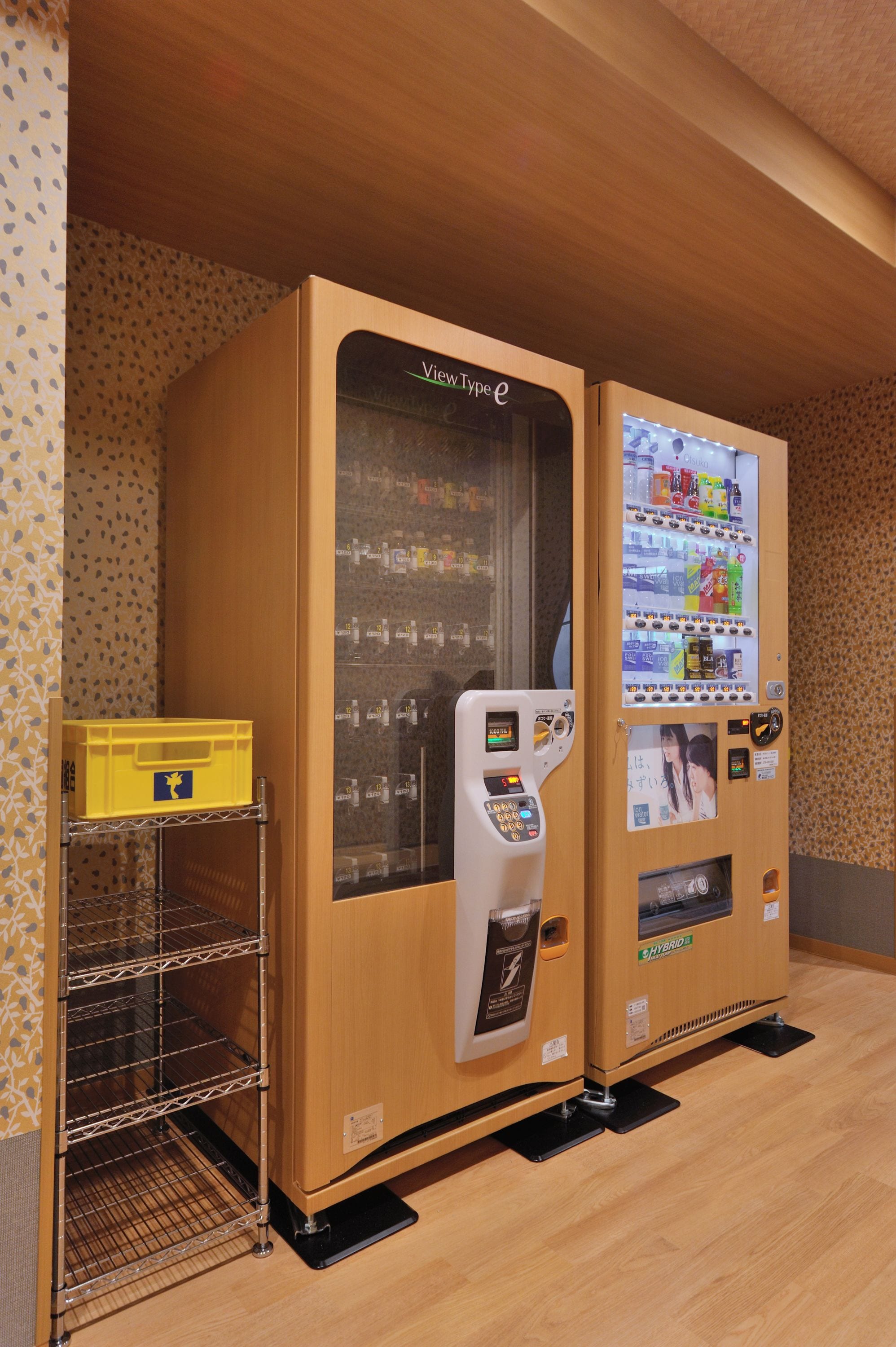 Two ViewType e vending machines with a yellow storage box and metal shelves.