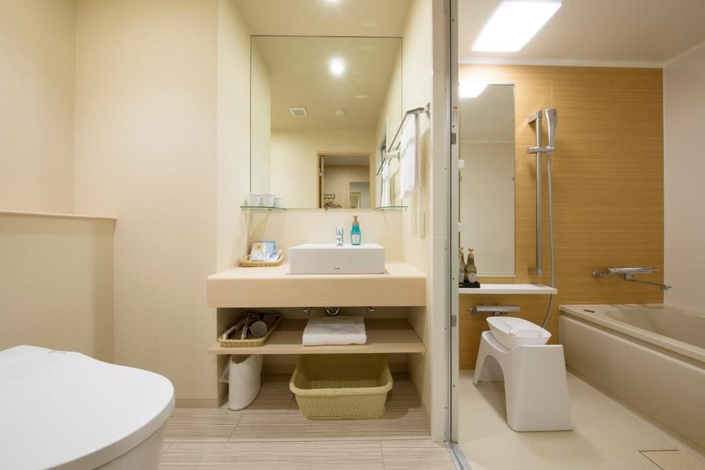 A modern bathroom with a bathtub, a separate shower area, and a toilet.
