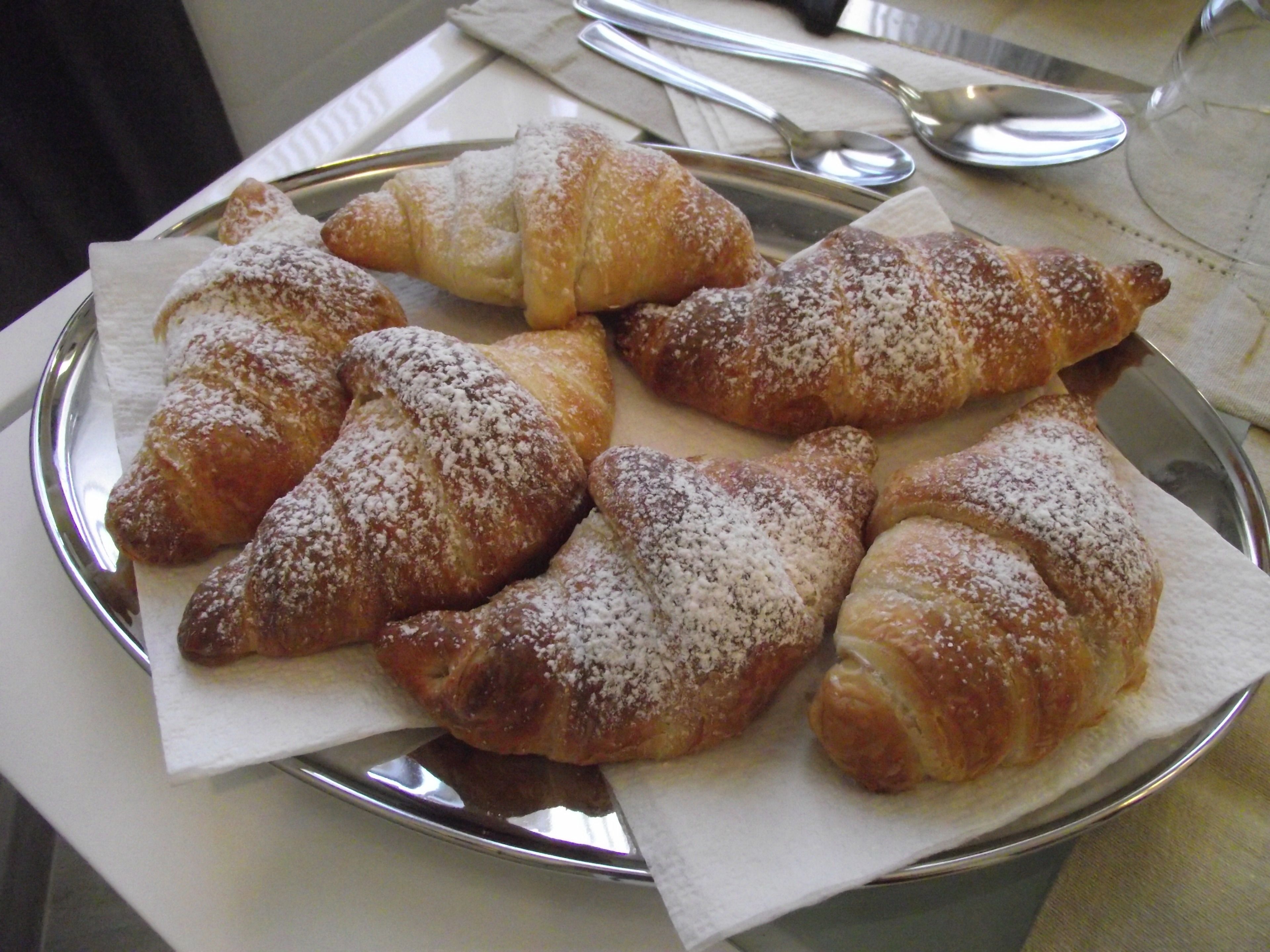 A plate of pastries dusted with powdered sugar.
