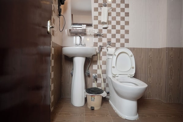 A bathroom with a toilet, sink, and shower. - Mala Suites Thamel (Kathmandu)