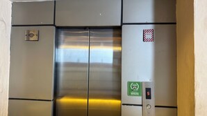 A metallic elevator interior with a digital display showing the number 5, a fireman's switch, and a plaque indicating a 2016 Travelers' Choice award. - Mala Suites Thamel (Kathmandu)