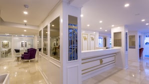 A modern hotel lobby with a reception desk, seating area, and a staircase leading to upper floors. - Wise Hotel Spa & Adult Only (Antalya)