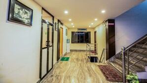 A hotel hallway with a marble floor, a staircase, and a sign indicating a restaurant. - Kathmandu Sunny Hotel (Kathmandu)