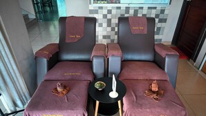 A room with two massage chairs, each covered with a 'Casa Spa' towel. A small table with a bowl and a white object is between the chairs. - Hotel Jelai Temerloh (Temerloh)