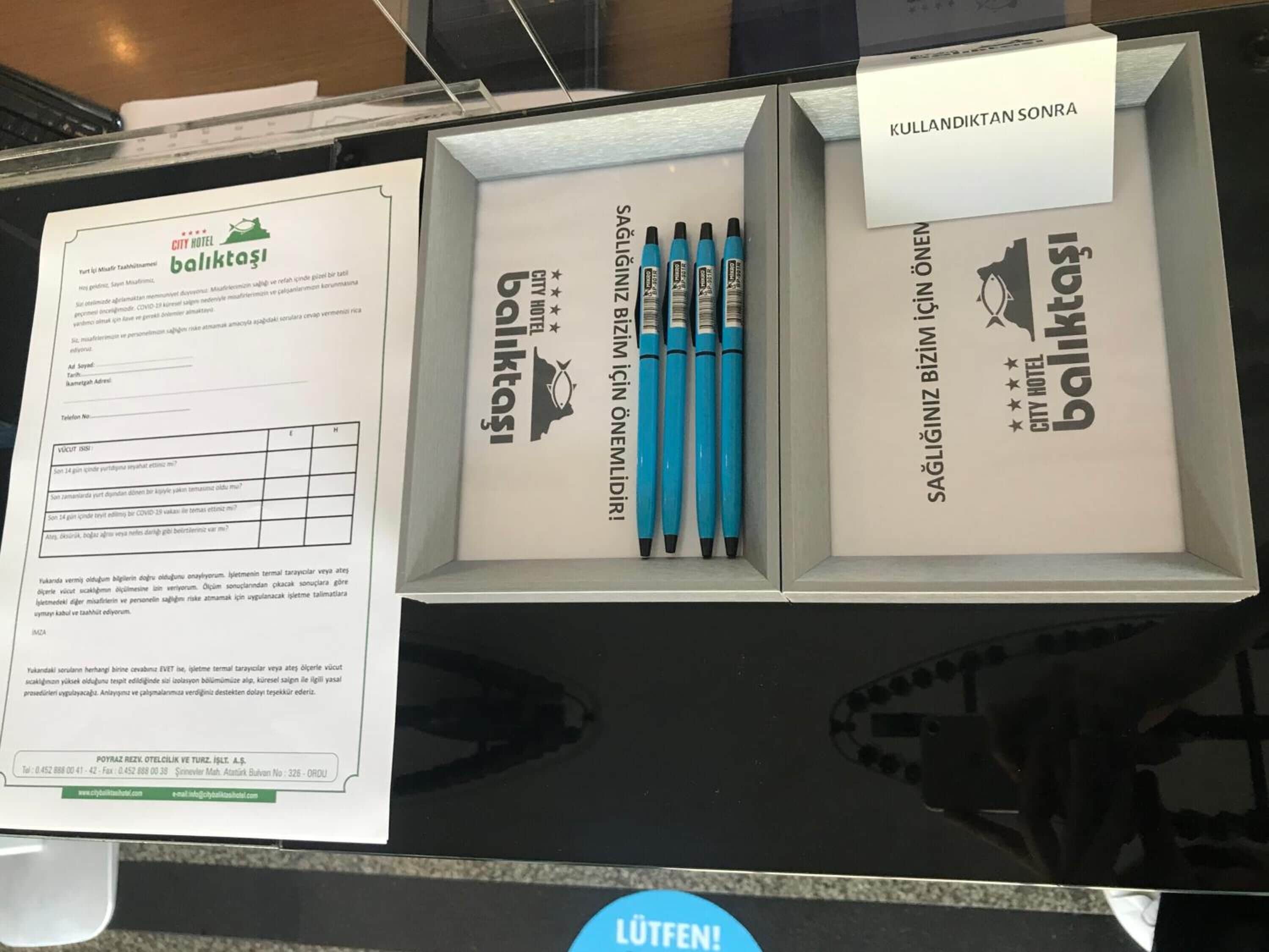 A City Hotel Baliktaş promotional display with a form, pens, and a thank you card.