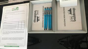 A City Hotel Baliktaş promotional display with a form, pens, and a thank you card.