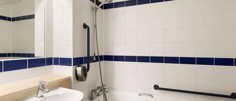 A bathroom with a white sink, a bathtub, and a shower.