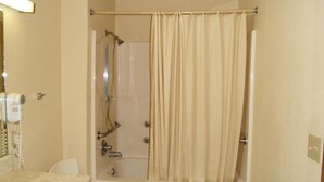 A bathroom with a bathtub, shower, and a toilet. - Western Motel of Camilla (Camilla)