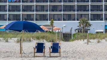 On the beach, white sand, beach towels, beach bar