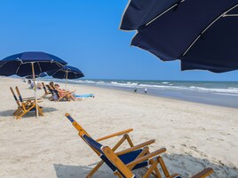 On the beach, white sand, beach towels, beach bar