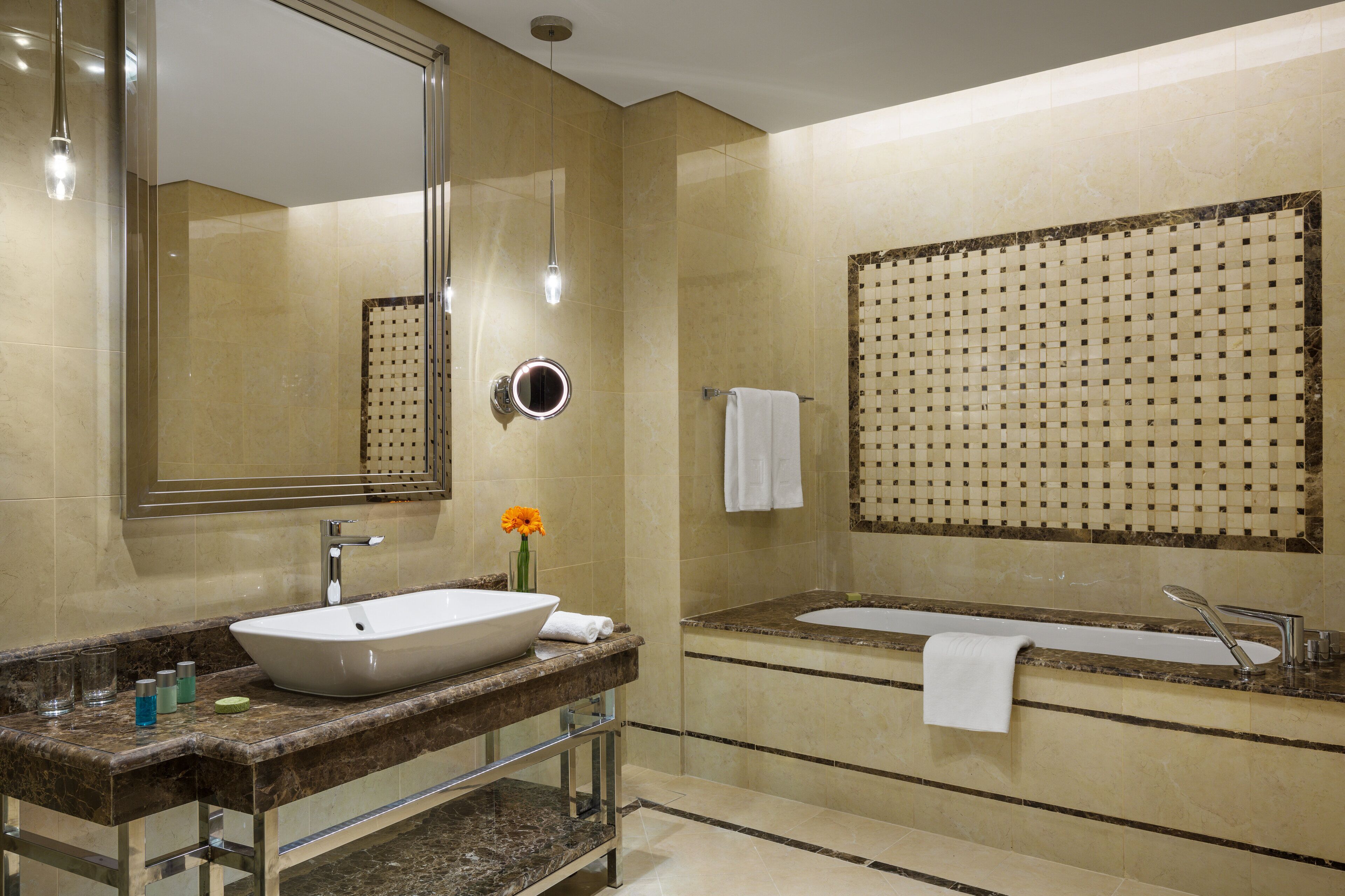 A modern bathroom with a large mirror, a vessel sink, a freestanding bathtub, and a towel rack.