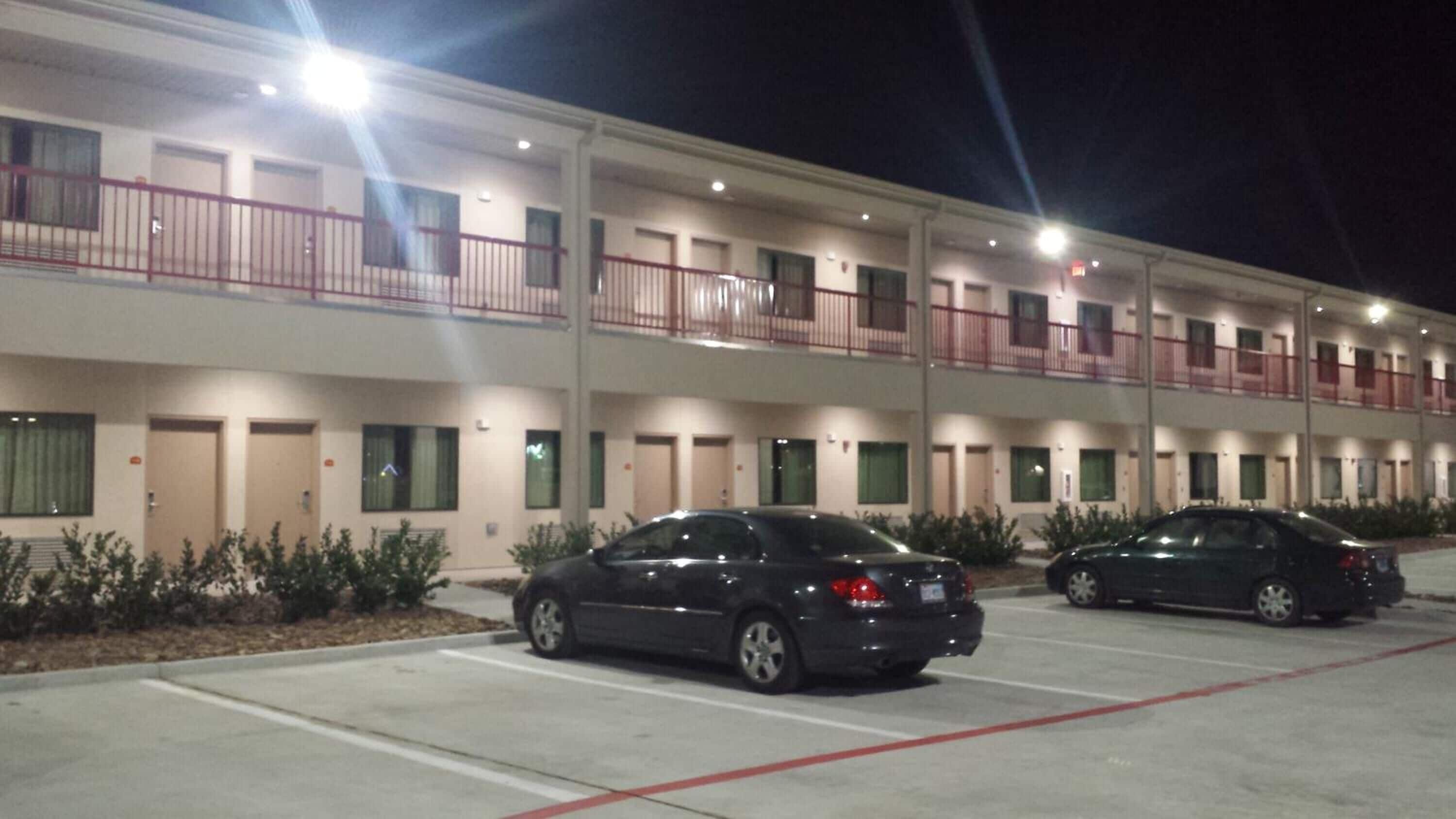 A multi-story hotel with a parking lot.