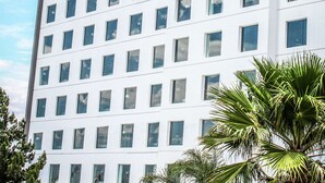 A multi-story hotel building with a prominent "Hilton" sign.