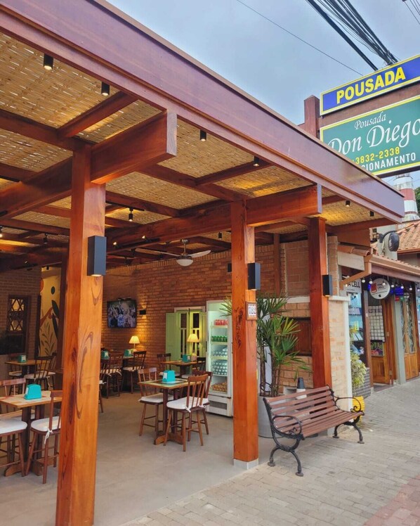 Step into Pousada Don Diego, where a rustic pergola and wooden architecture create a warm and inviting atmosphere.
