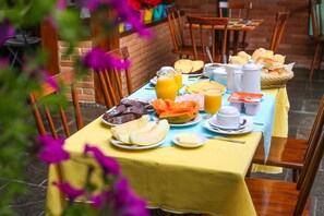 Enjoy a leisurely breakfast amidst a charming outdoor setting with a beautifully set table.