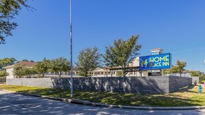 A hotel sign with "Home Place Inn" and "Now Open" indicating the establishment is operational. - Home Place Inn Spring I-45 North & 1960 (Houston)