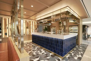 A modern bar area with a blue-tiled counter, glassware, and bottles. - voco Seoul Myeongdong by IHG (Seoul)
