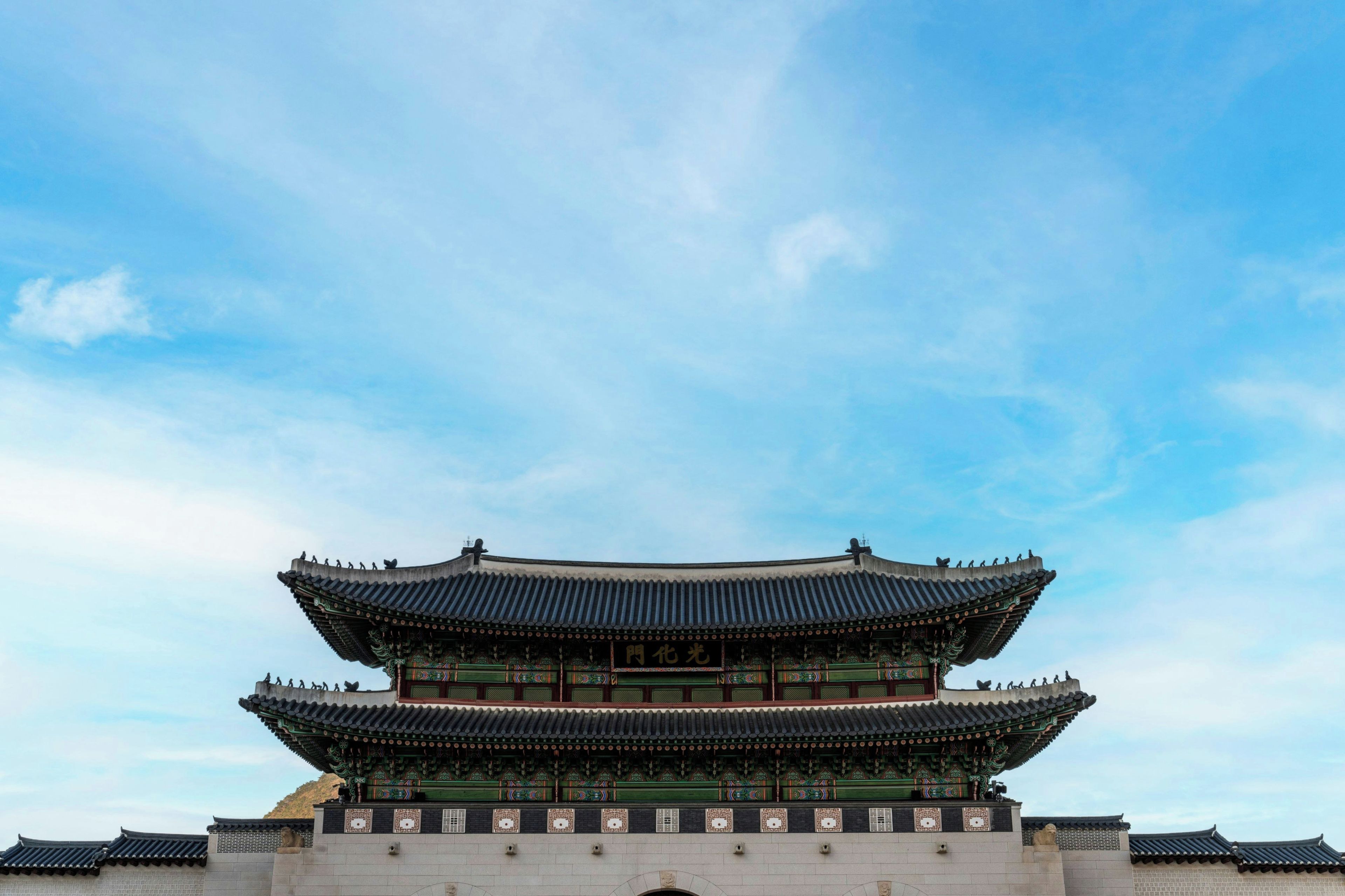 A traditional Korean palace with a prominent multi-tiered roof structure.