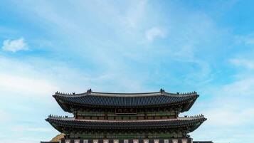 A traditional Korean palace with a prominent multi-tiered roof structure.