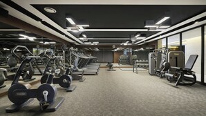 A modern gym with various exercise equipment, including treadmills and weight machines, arranged in a spacious layout. - voco Seoul Myeongdong by IHG (Seoul)