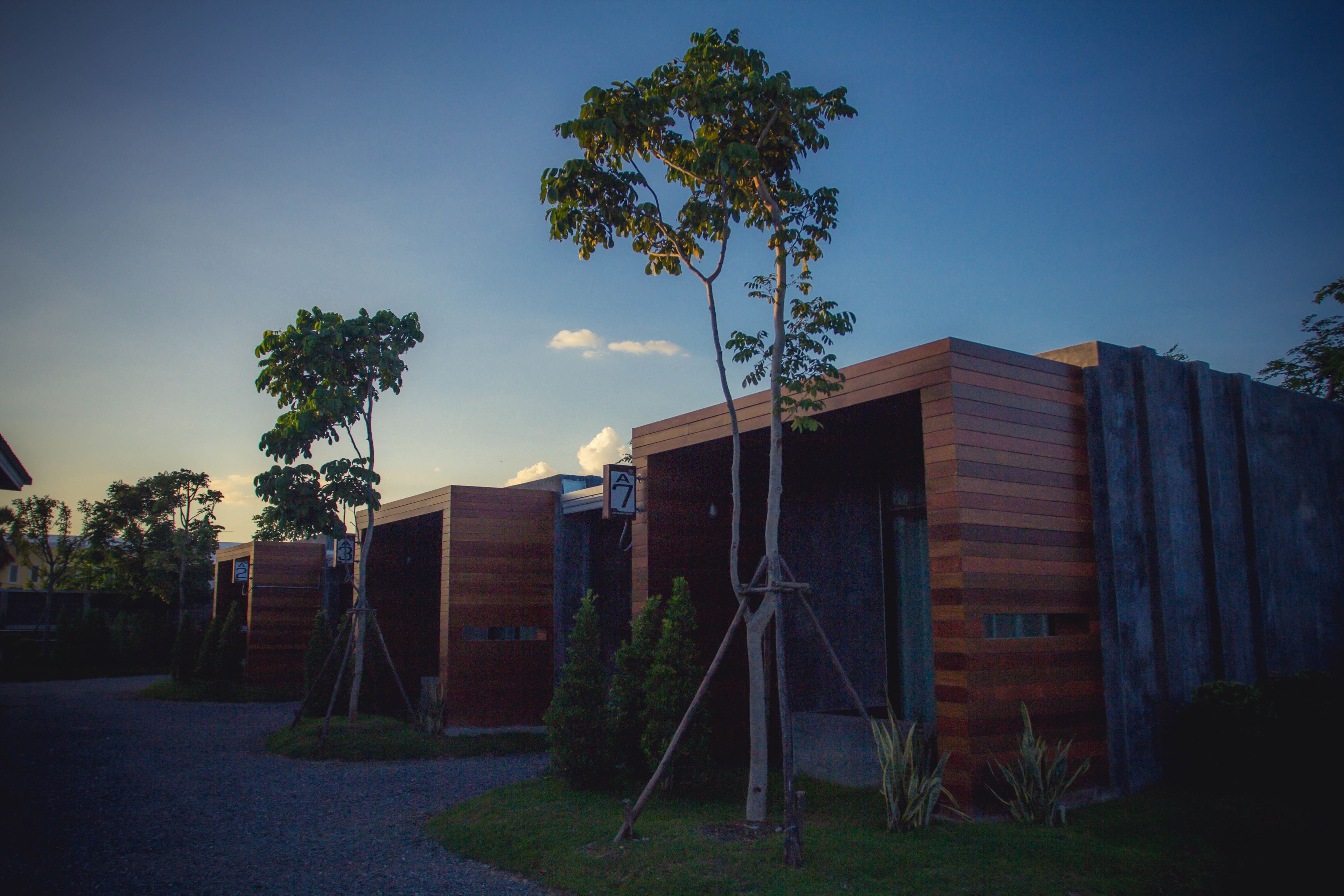 A modern building with a wooden facade and a clear sky.