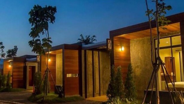 A modern hotel with a series of connected rooms, each with a wooden facade and large windows. - The Infinite Resort Nakhon Sawan (Nakhon Sawan)