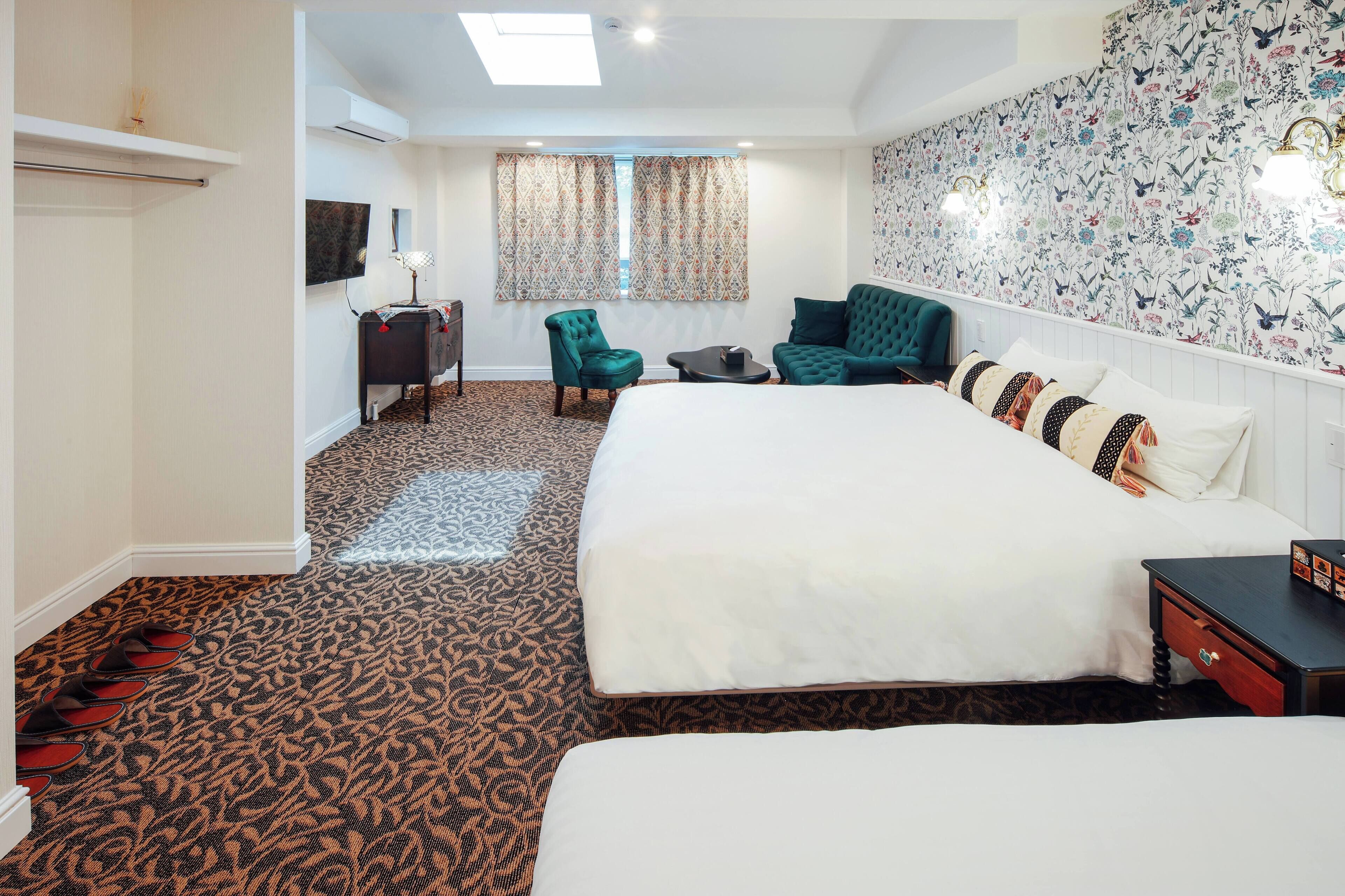 A hotel room with a large bed, a desk, a chair, and a TV.