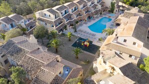 A resort with multiple buildings, a swimming pool, and palm trees. - Résidence Lago Verde (Porto-Vecchio)