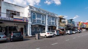 A street view with a hotel named "Vintage Hotel" and various shops.