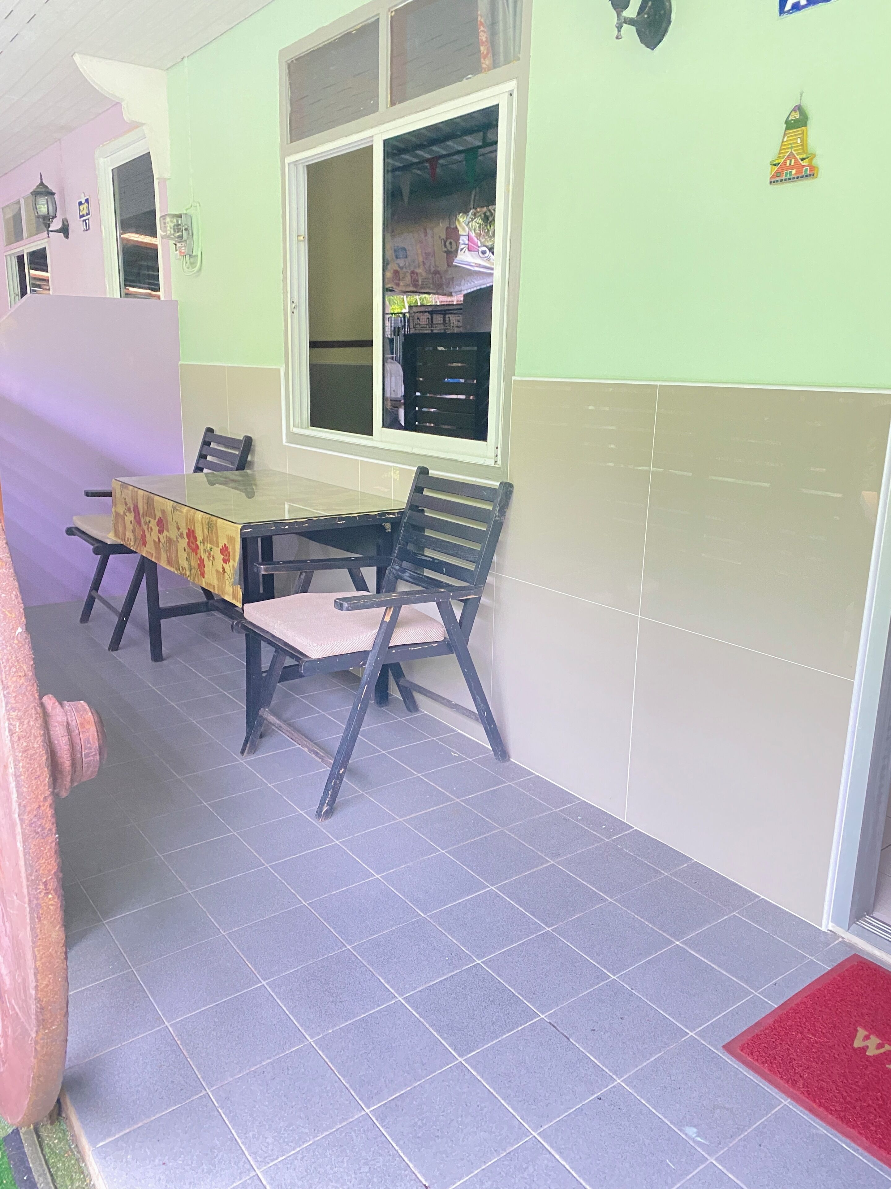 A room with a table and chairs, a window, and a door.