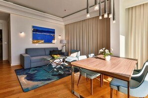 Suite Deluxe | Área de sala de estar | Televisión LCD de 40 pulgadas con canales vía satélite y televisión 