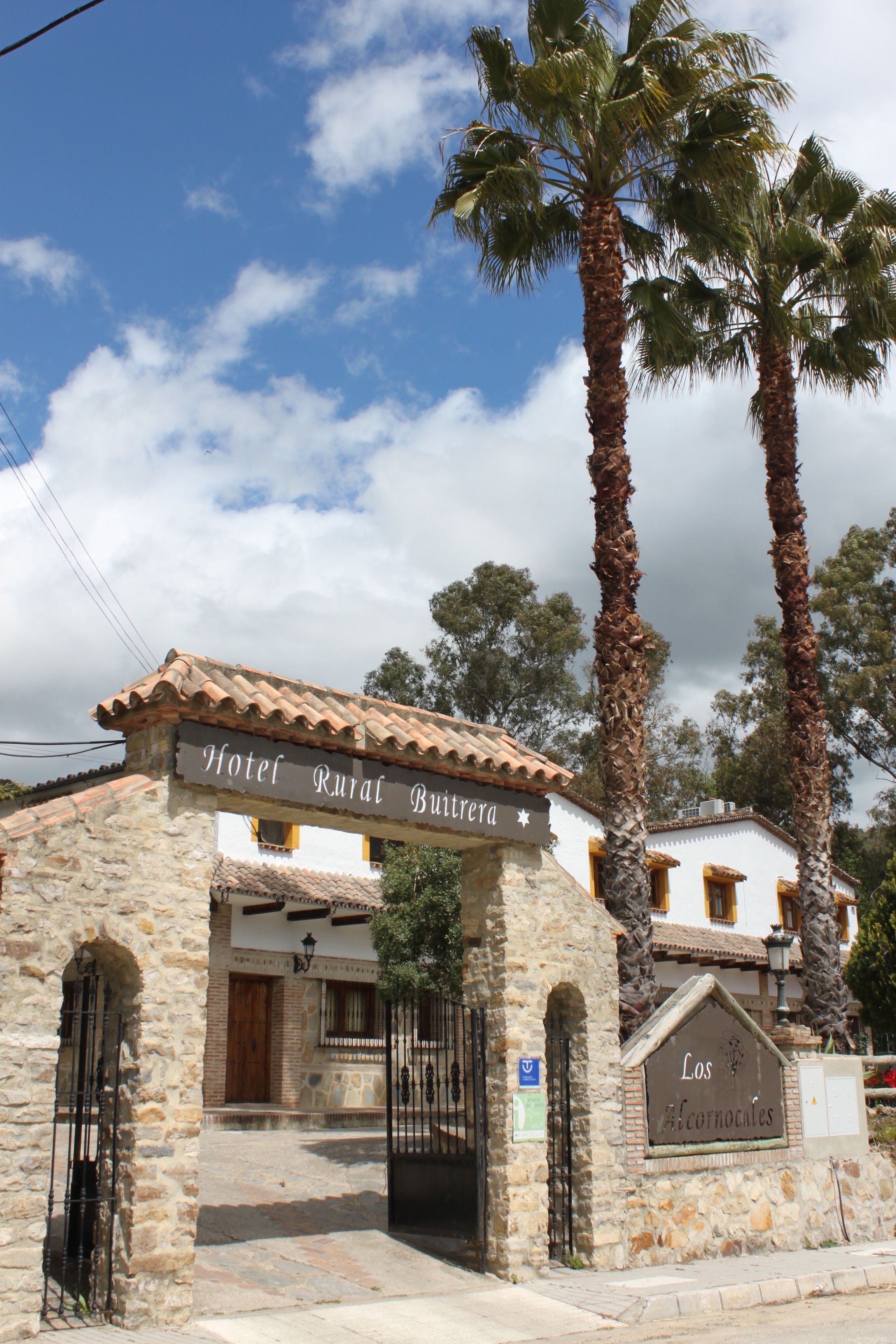 A rustic stone building with a sign reading "Hotel Rural Butrera."