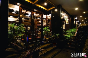A hotel entrance with a checkered floor pattern, potted plants, and a staircase leading to the interior. - Seasons Hotel & Convention Center (Margao)