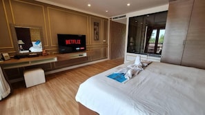 Une chambre d’hôtel avec un lit, une télévision, un bureau et une fenêtre.