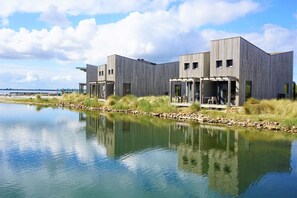 A modern building with a flat roof, large windows, and a flat facade.