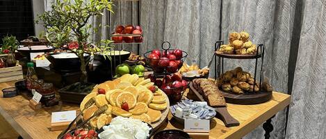 Una mesa de buffet con diferentes opciones de comida, como panqueques, crema batida y Nutella.