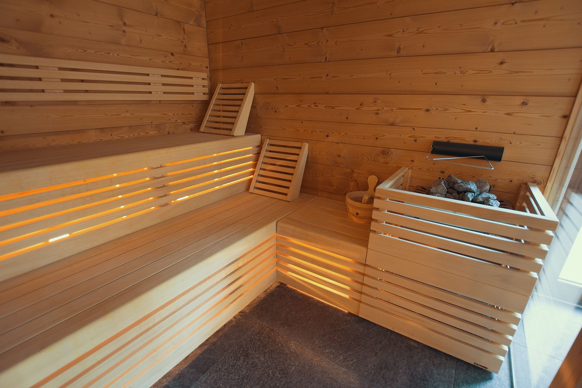 A sauna with wooden benches and benches with slats.