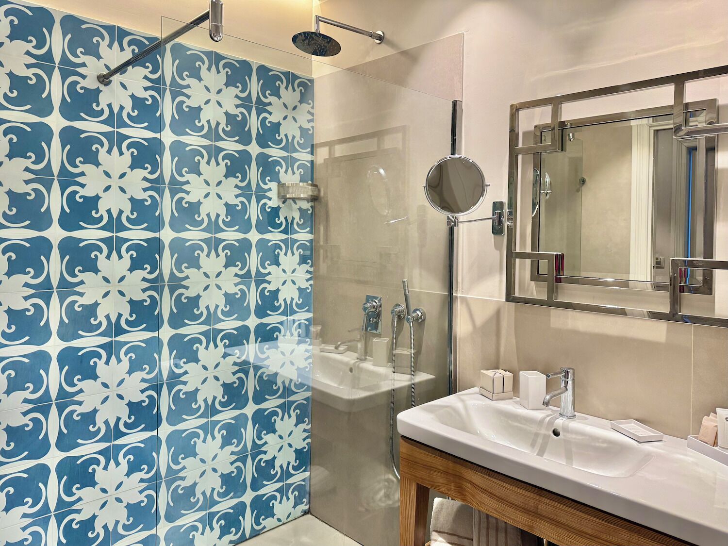A bathroom with a shower, a sink, and a mirror.