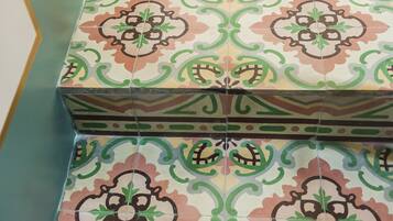 A tiled floor with a repeating floral pattern.
