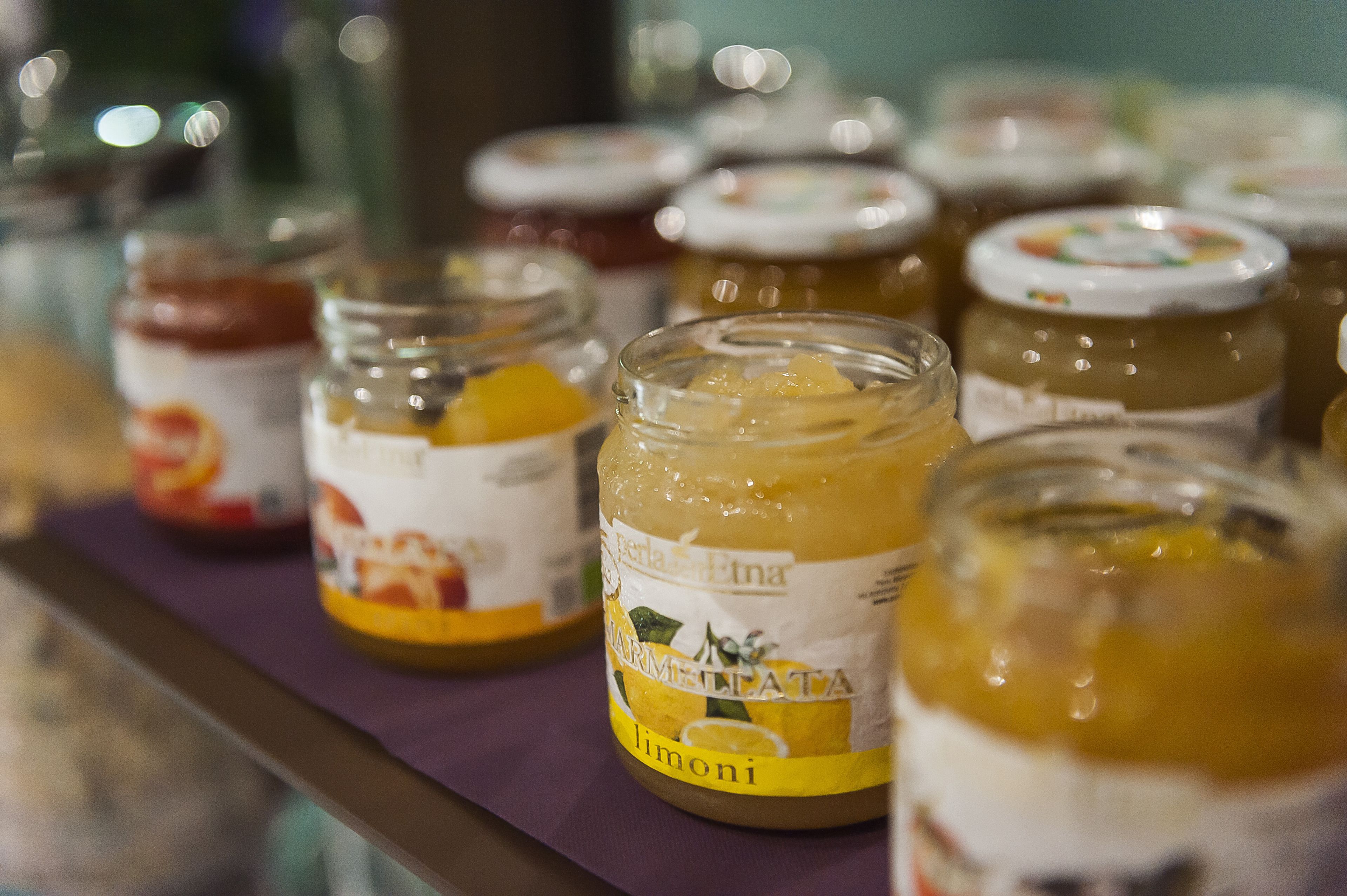 A display of jars with labels, likely containing food items.