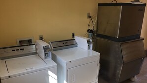 A laundry area with two white washing machines and a stainless steel refrigerator. - Blarney Inn (Shamrock)