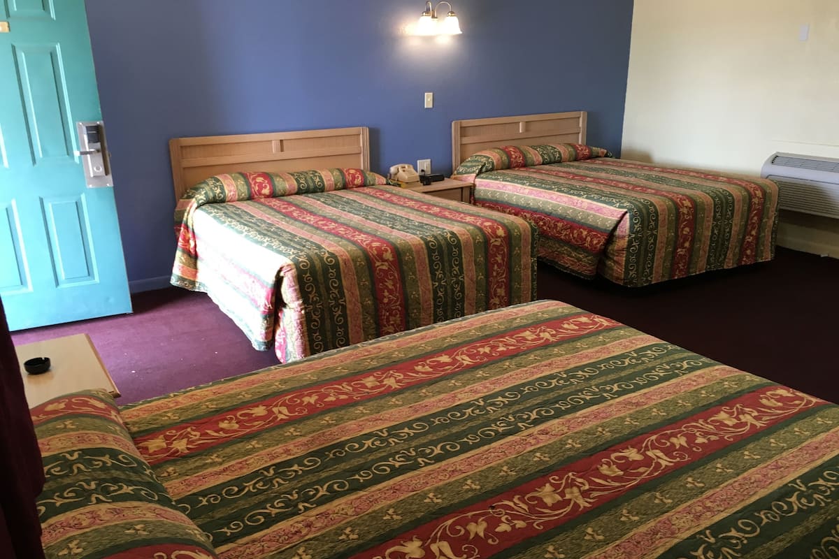 Room, 3 Queen Beds | Desk, blackout drapes, iron/ironing board, free cribs/infant beds