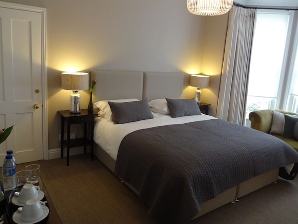 Relax in comfort with a large bed, bedside tables, and a small table for your essentials.