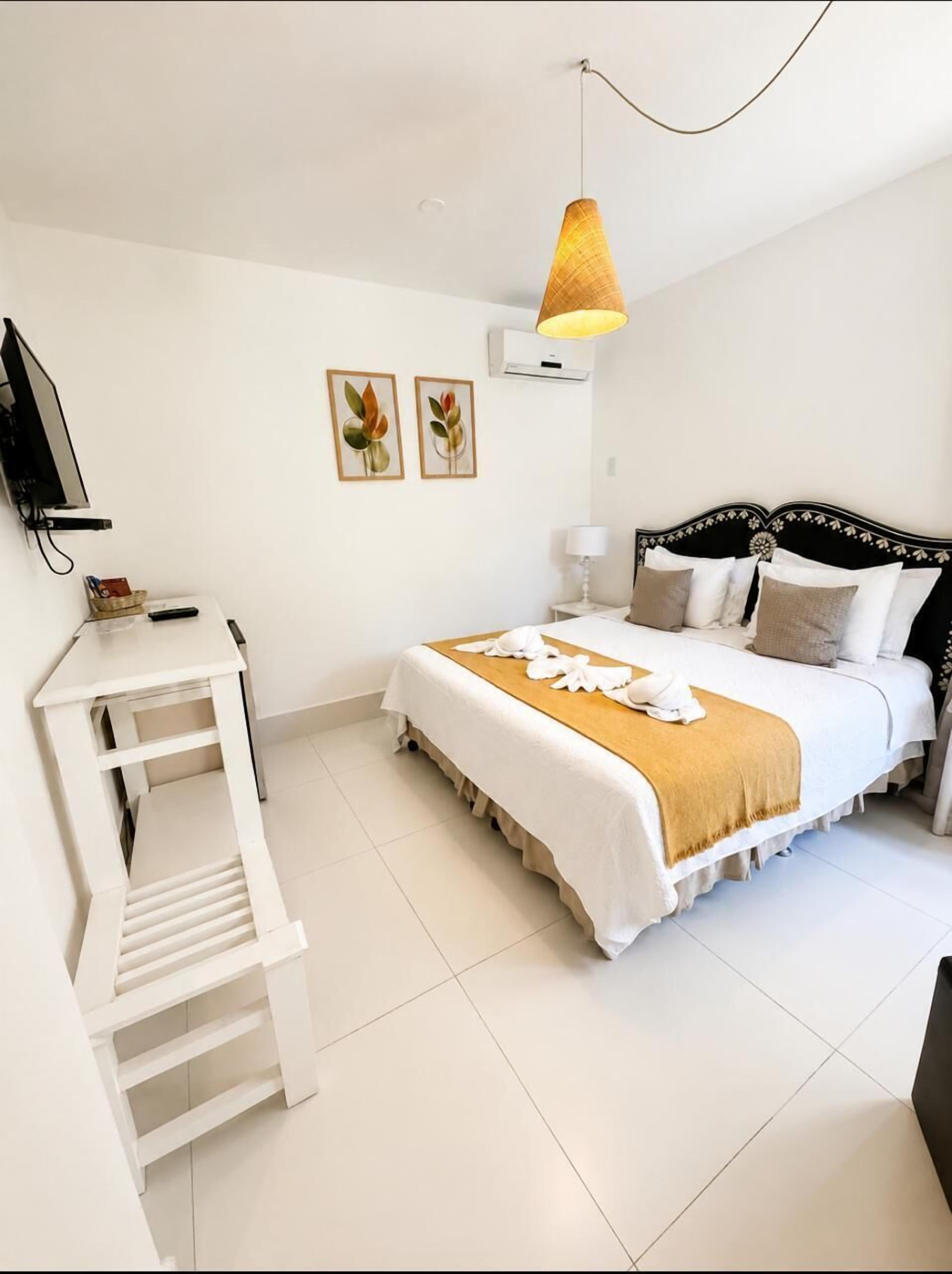 Deluxe Double Room | Minibar, in-room safe, individually decorated, blackout drapes