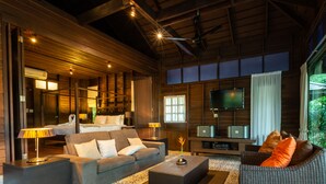 A spacious living area with a sofa, a coffee table, and a television.