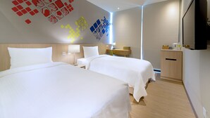 A hotel room with two beds, a flat-screen TV, a desk with a lamp, and a wall with geometric patterns. - Park City Inn & Hostel - Yonghe Taipei (New Taipei City)
