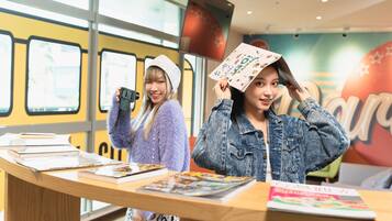 A bookstore with books on display and a large window in the background.