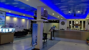 A reception area with a clock and a sign labeled "RECEPTION" on the wall. - New Travel Beach Resort (Tha Mai)