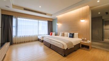 A modern hotel room with a large bed, a TV, a wooden floor, and a shower area.
