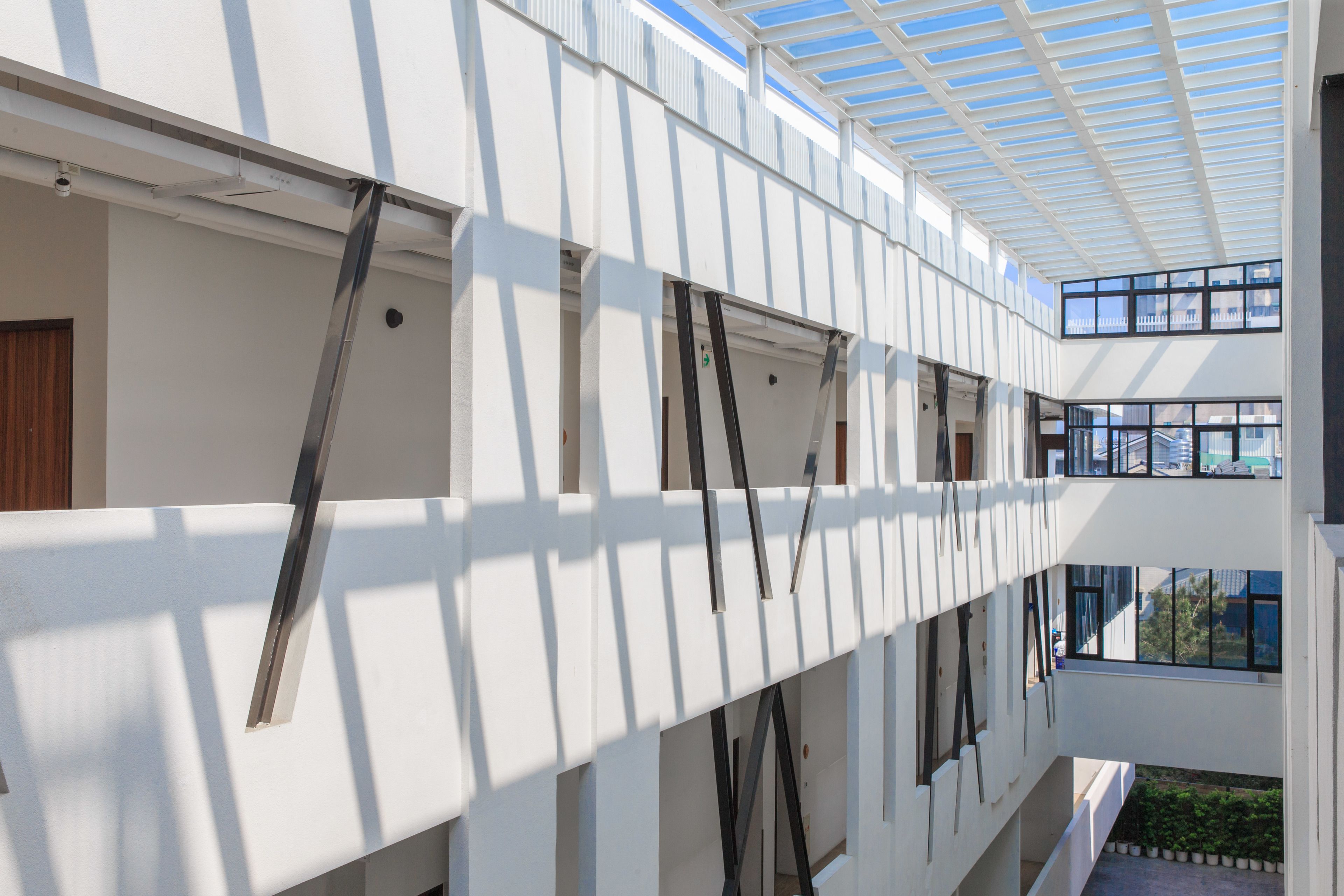 A multi-level building with a glass ceiling, allowing natural light to enter.